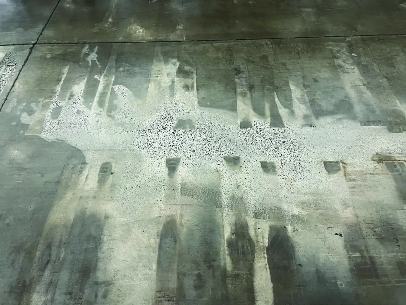 Columbia Distribution before treatment: severely deteriorated concrete with the surface eaten away and the aggregate exposed