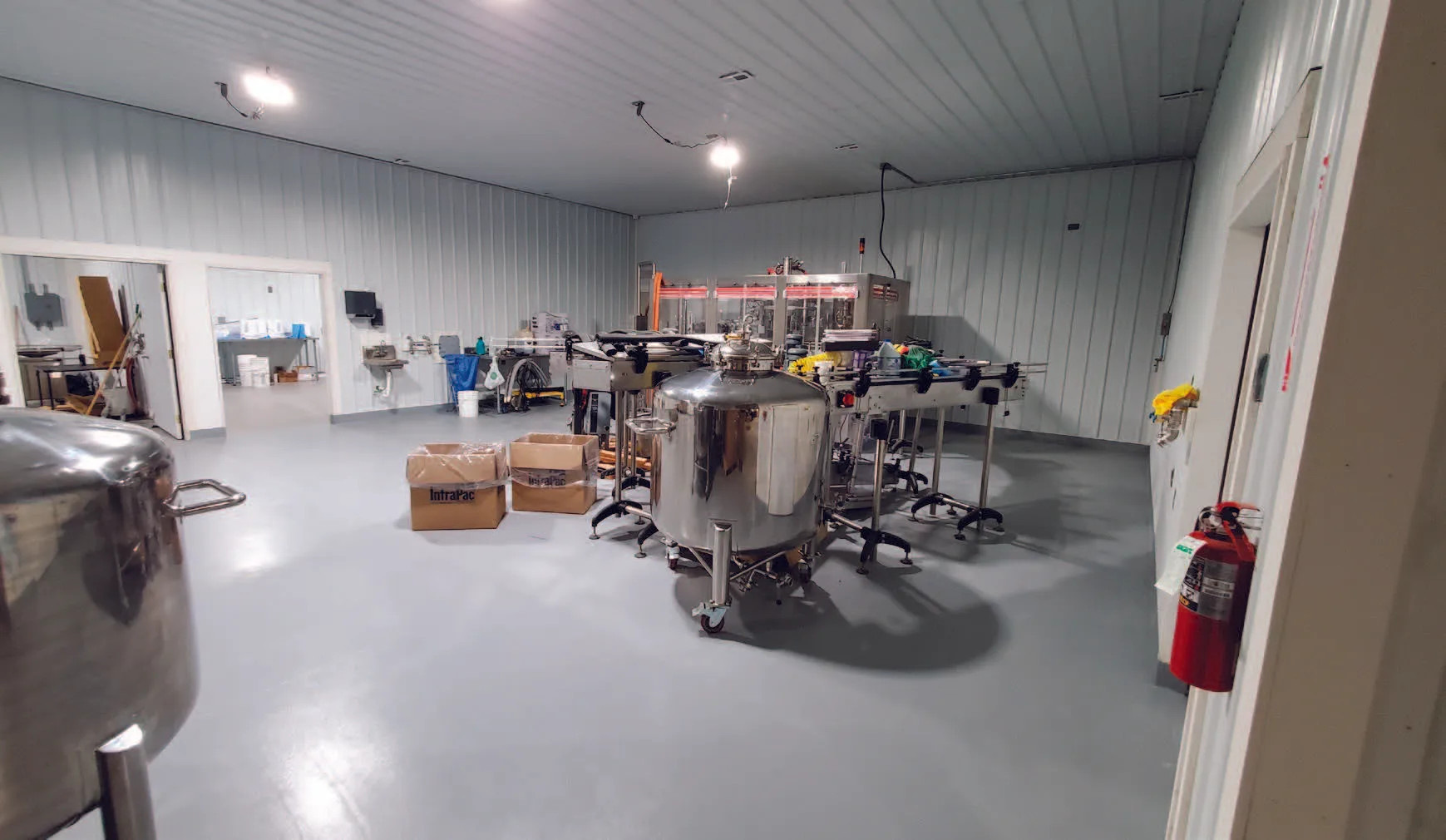 Food processing floor coating, coated concrete in a beverage production room with stainless tanks