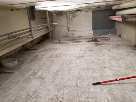 Damp CMU block walls at the Tyson Foods mechanic shop before ceramic surface treatment